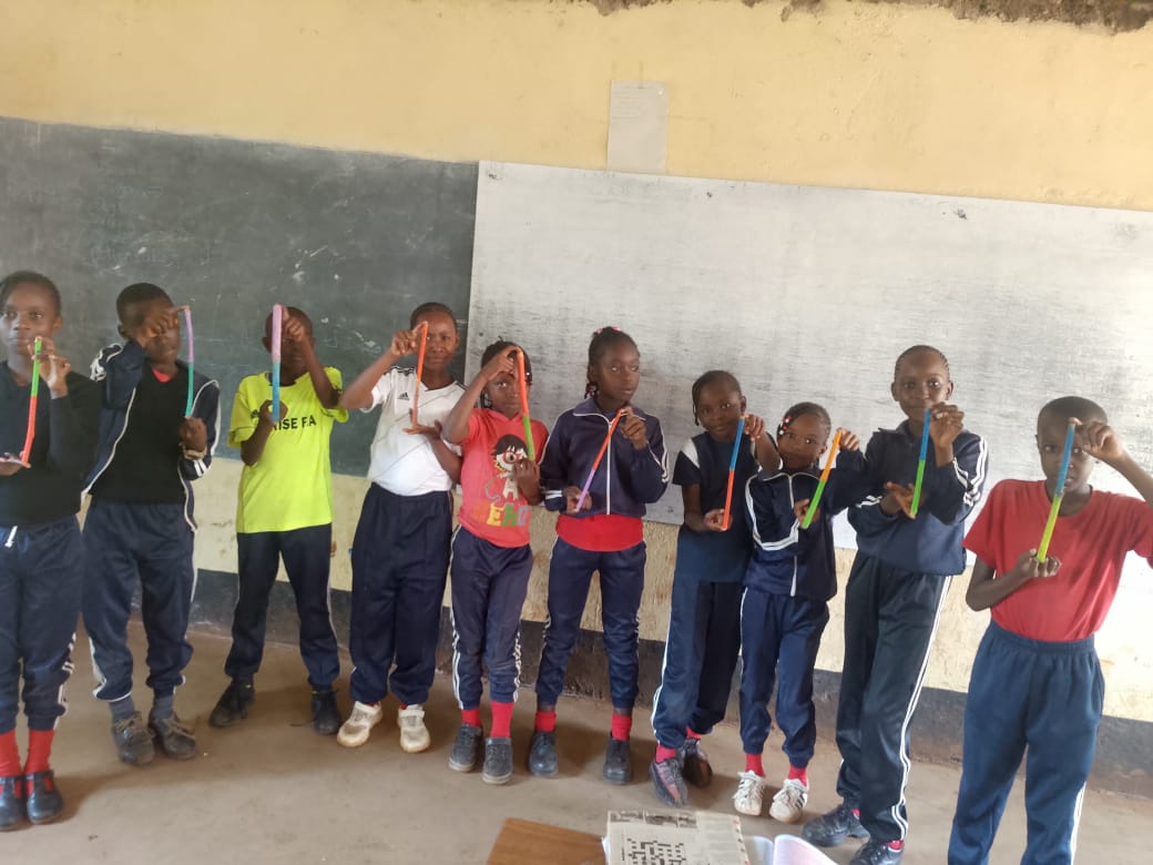 Pupils in class holding up a craft activity