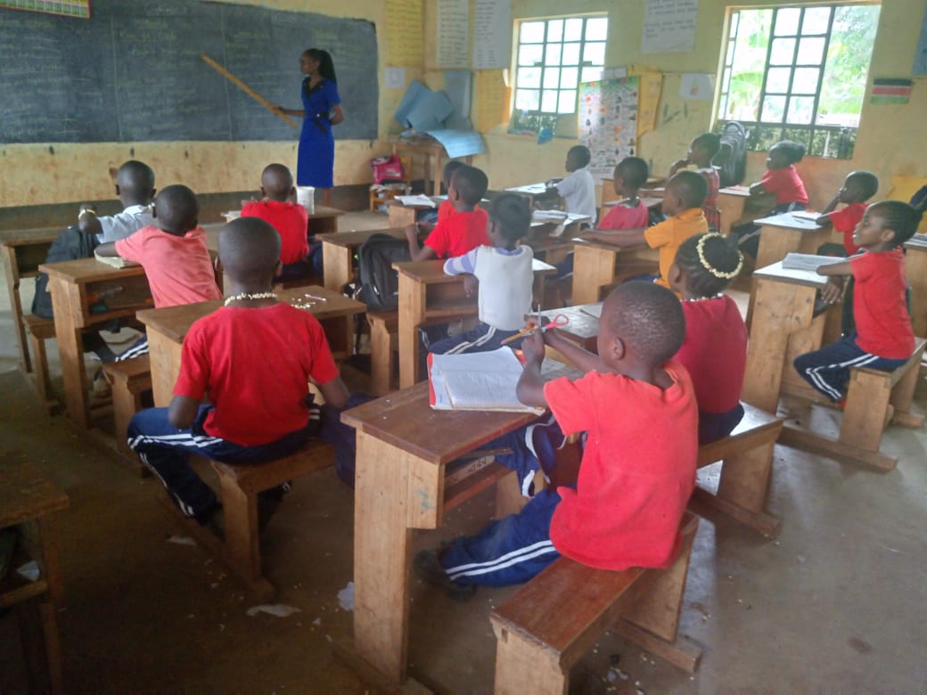 Teacher leading a lesson at the chalkboard