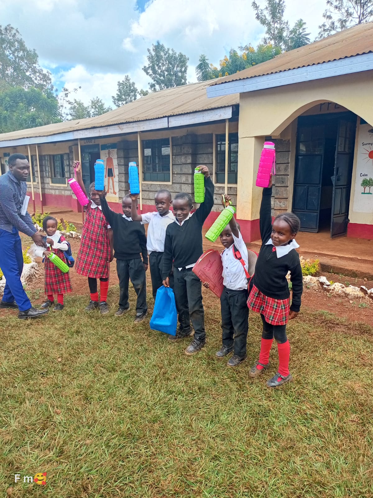 Pupils holding up new water bottles