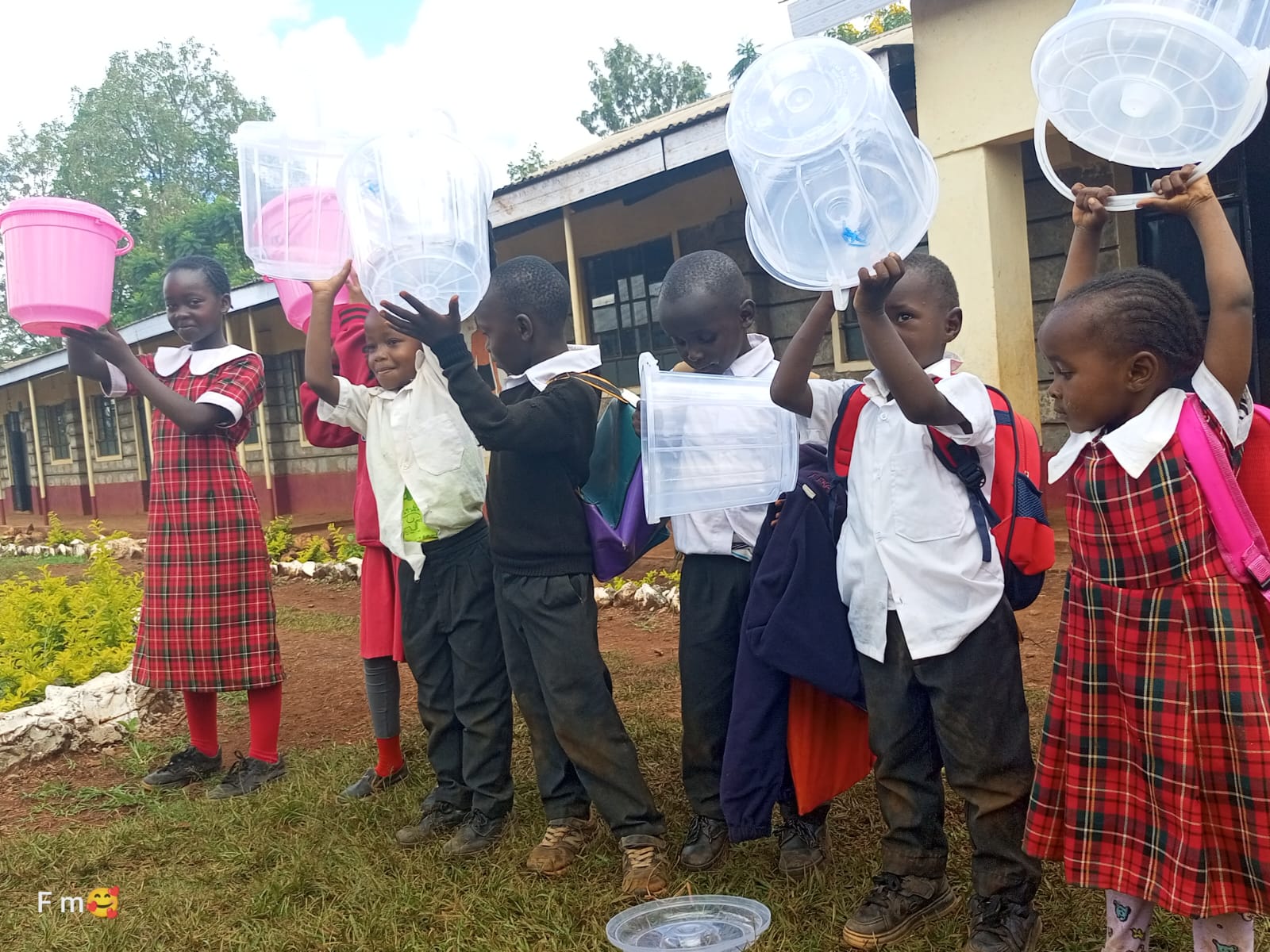 Pupils holding up donated cups