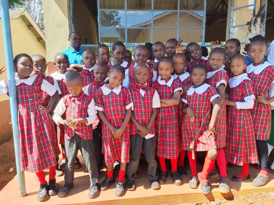 Group of pupils in school uniform posing for a photo